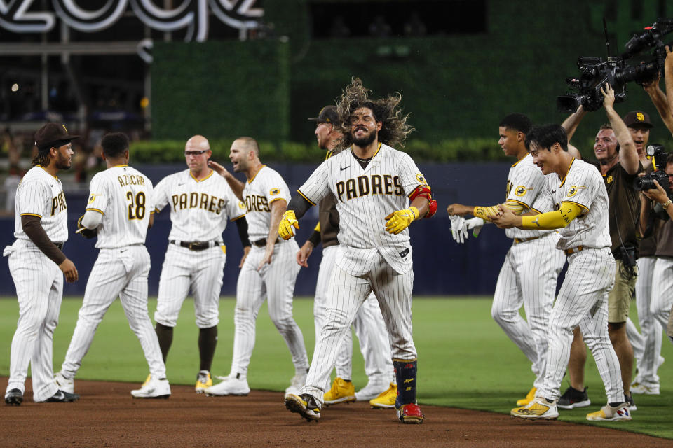 San Diego Padres' Jorge Alfaro celebrates after hitting a two-run single against the Arizona Diamondbacks during the ninth inning of a baseball game Tuesday, Sept. 6, 2022, in San Diego. The Padres won 6-5. (AP Photo/Brandon Sloter)