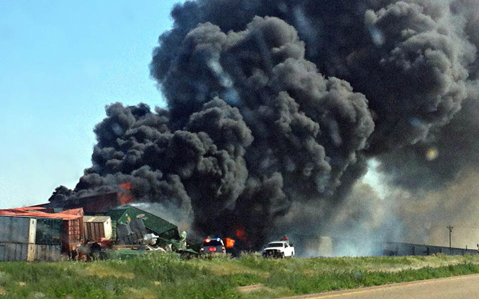 Smoke rises from two cargo trains that collided two miles east of Goodwell, Okla. on Sunday, June 24, 2012. A total of four people were on the trains, and one was reportedly killed in the accident. (AP Photo/The Guymon Daily Herald, Trudy Hart)