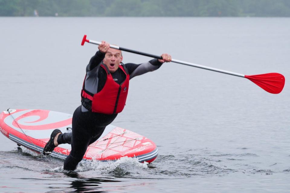 Liberal Democrat leader Sir Ed Davey falls in while paddleboarding on Windermere (PA)