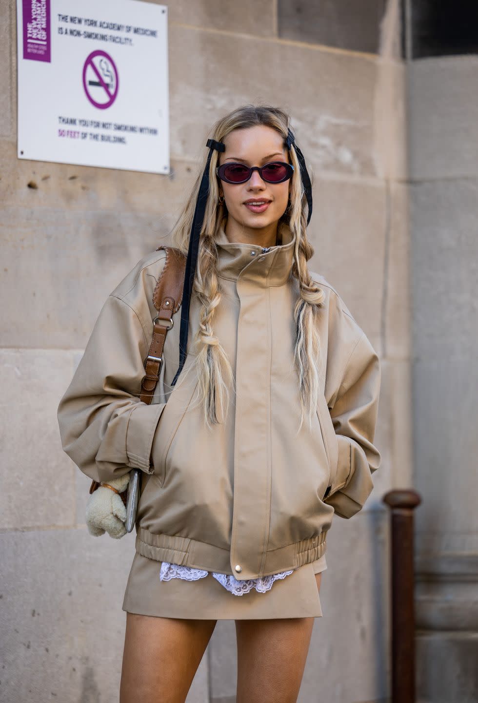 new york, new york february 11 a guest wears brown beige jacket, skirt, bag outside sandy liang during new york fashion week on february 11, 2023 in new york city photo by christian vieriggetty images