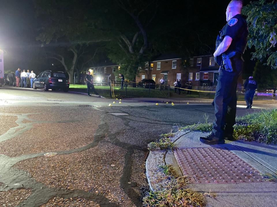 Providence police investigators process a crime scene on June Street  at the Chad Brown housing complex Thursday night after three young men were shot and injured.