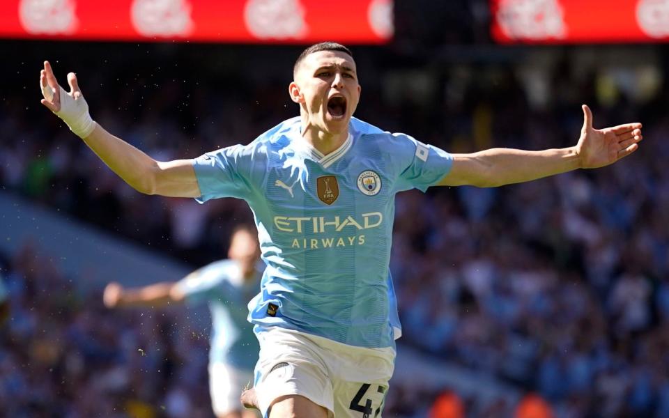 Manchester City's Phil Foden celebrates after scoring his side's opening goal during the English Premier League soccer