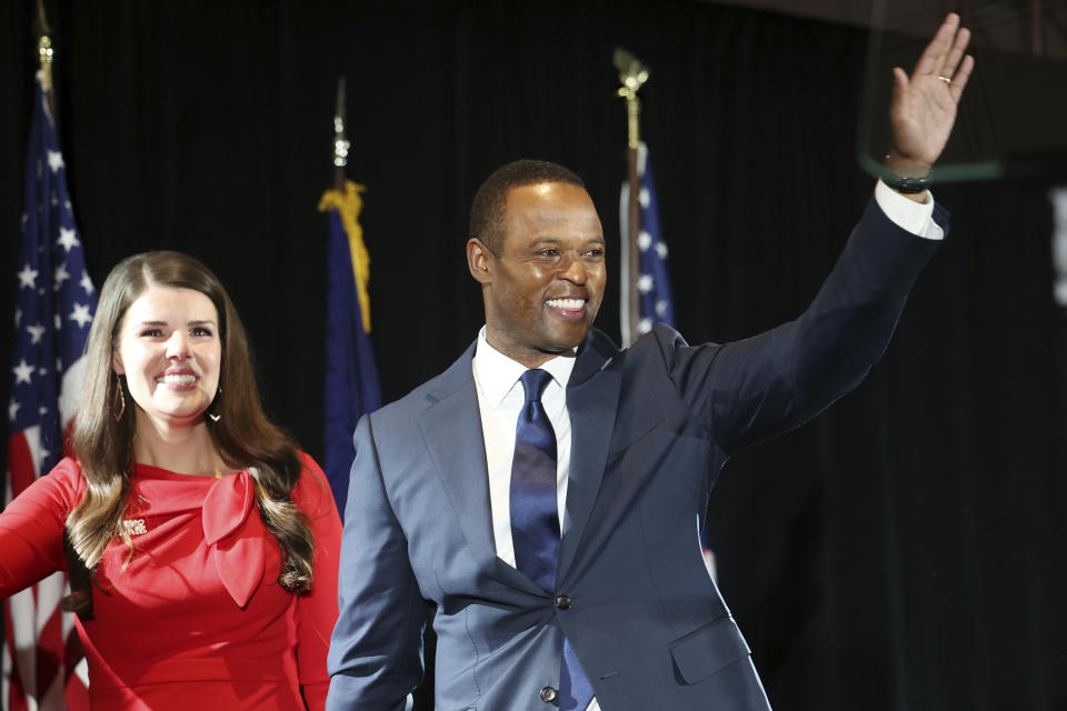 Republican gubernatorial candidate Daniel Cameron, right, and his wife Makenze leave the stage after conceding to supporters during an election night watch party in Louisville, Ky., Tuesday, Nov. 7, 2023. (AP Photo/James Crisp)