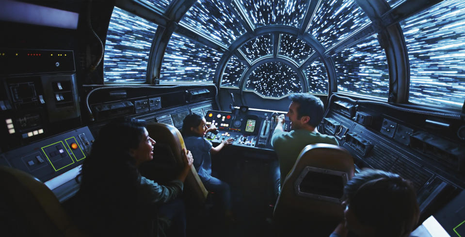 This rendering released by Disney and Lucasfilm shows people on the planned Inside Millennium Falcon: Smugglers Run attraction, part of Star Wars: Galaxy's Edge a 14-acre area set to open this summer at the Disneyland Resort in Anaheim, California, then in the fall at Disney's Hollywood Studios in Orlando, Florida. (Disney Parks/Lucasfilm via AP)