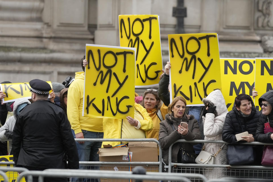 FILE -Protesters hold placards with the message "Not my king" before Britain's King Charles III arrives to attend the annual Commonwealth Day service at Westminster Abbey in London, Monday, March 13, 2023. Britain is one of the world's oldest democracies, but some worry that essential rights and freedoms are under threat. They point to restrictions on protest imposed by the Conservative government that have seen environmental activists jailed for peaceful but disruptive actions. (AP Photo/Frank Augstein, File)