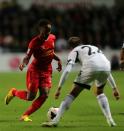 Swansea City's Angel Rangel (right) and Liverpool's Raheem Sterling battle for the ball