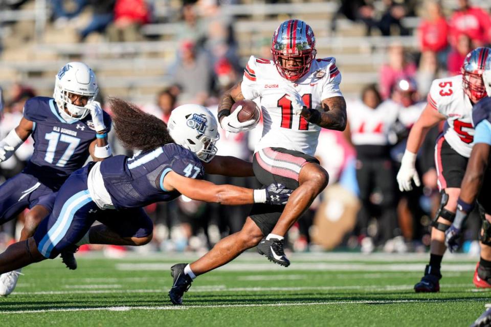 Dec 18, 2023; Charlotte, NC, USA; Western Kentucky Hilltoppers wide receiver Malachi Corley (11) runs the ball against Old Dominion Monarchs linebacker Koa Naotala (47) during the first quarter at Charlotte 49ers’ Jerry Richardson Stadium. Mandatory Credit: Jim Dedmon-USA TODAY Sports Jim Dedmon/Jim Dedmon-USA TODAY Sports