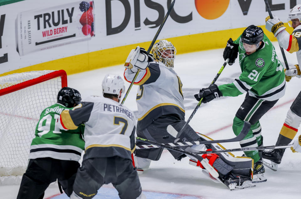 Dallas Stars left wing Jason Robertson (21) scores against Vegas Golden Knights goalie Adin Hill, center, during the first period of Game 4 of the NHL hockey Stanley Cup Western Conference finals Thursday, May 25, 2023, in Dallas. (AP Photo/Gareth Patterson)