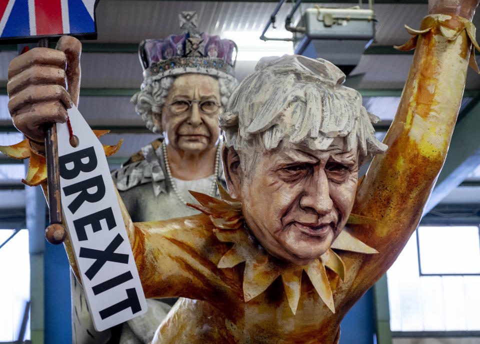 Figures depicting British Prime Minister Boris Johnson, right, and the Queen Elizabeth II are shown during a press preview for the Mainz carnival, in Mainz, Germany, Tuesday, Feb. 18, 2020. (AP Photo/Michael Probst)