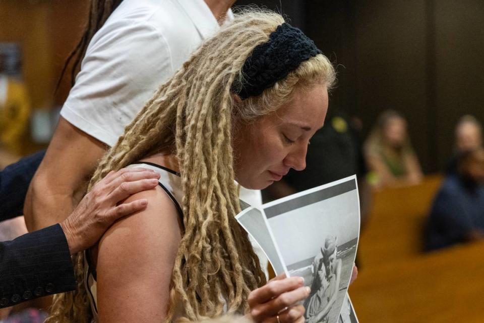 Sloan Kiser holds a photo of her father, Stan, during a sentencing hearing Thursday for Tracy Gordon, who was convicted of reckless homicide in the 2019 death of Stan Kiser in a boating accident on Lake Murray.