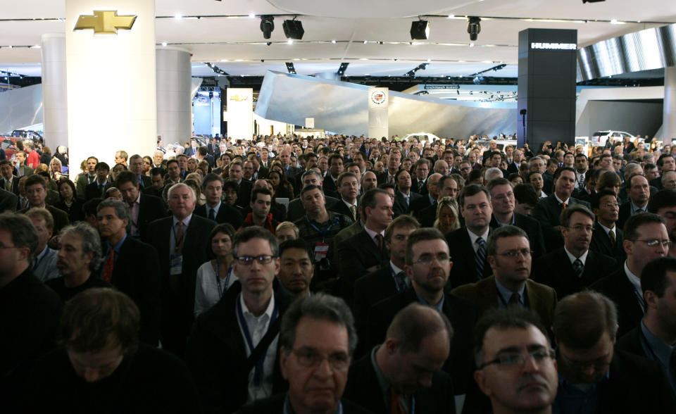 FILE - In this Sunday, Jan. 7, 2007, file photo, journalists crowd to view the unveiling of the Chevrolet Volt concept vehicle at the North American International Auto Show in Detroit. In 2013, about 5, 200 journalists from around the world attended the show.(AP Photo/Paul Sancya, File)