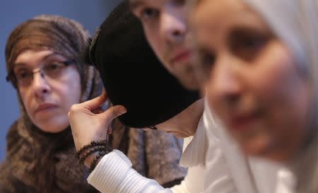 Students pursuing a diploma in "Multiculturalism, Secularism and Religion" listen to Professor Philippe Gaudin in classroom at the Catholic University of Paris (ICP) March 13, 2015. REUTERS/Christian Hartmann