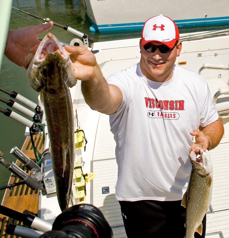 Joe Thomas hands off one of the fish caught on Lake Michigan Saturday April 28, 2007.  Thomas, was fishing with his father Eric and friend Joe Panos during the NFL draft in which he was selected by the Cleveland Browns with the third pick.