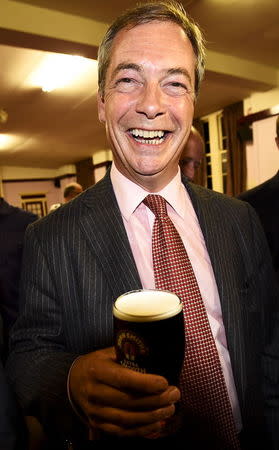 Nigel Farage, the leader of Britain's anti-EU party UKIP, enjoys a pint of beer as he celebrates after a hustings event at The Oddfellows Hall in Ramsgate, south east England in this August 26, 2014 file photo. REUTERS/Dylan Martinez/Files