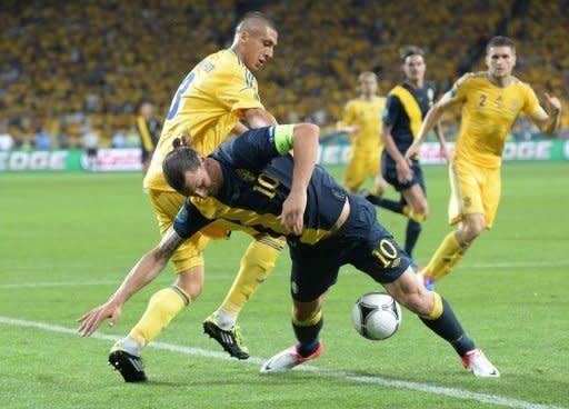 Swedish forward Zlatan Ibrahimovic (C) vies with Ukrainian defender Yevhen Khacheridi during the Euro 2012 football match Ukraine vs Sweden in Kiev. Ukraine won 2 to 1