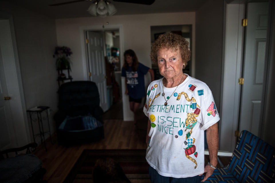 Linda Prevatte and Mary Jane Allen stand in their home in Lumberton, watching floodwaters rise and deciding whether to evacuate.