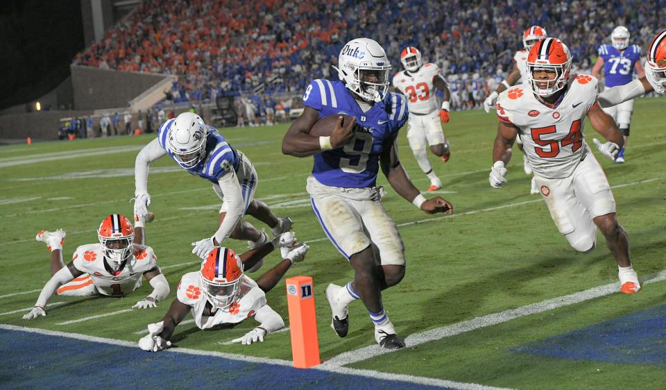 Duke running back Jaquez Moore (9) scores ahead of Clemson linebacker Jeremiah Trotter Jr. Moore, a former Suwannee High School standout, helped the Blue Devils to Monday's 28-7 upset win.