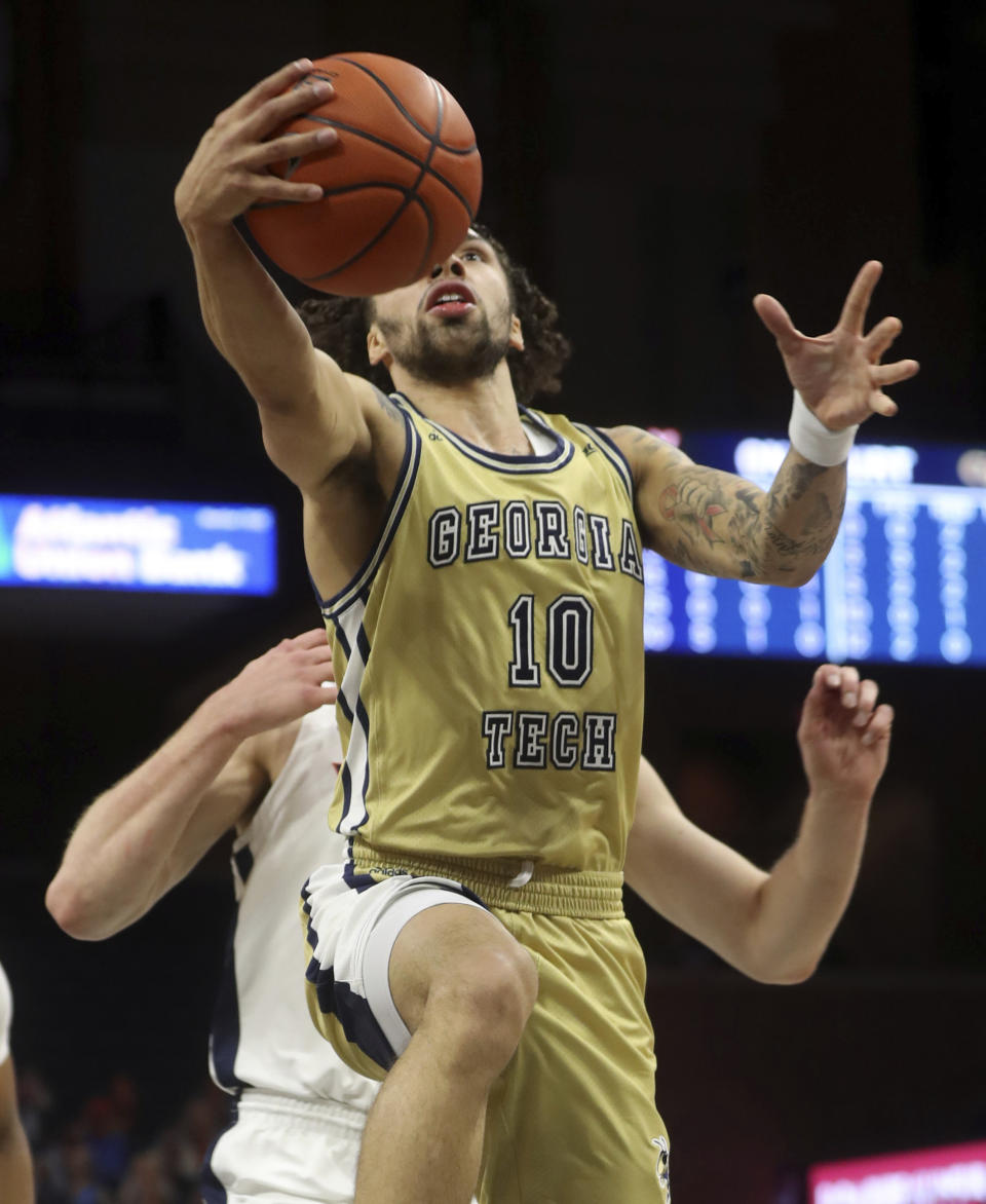 Georgia Tech guard Jose Alvarado (10) shoots in front of Virginia guard Casey Morsell (13) during an NCAA college basketball game Saturday, Jan. 23, 2021, in Charlottesville, Va. (Andrew Shurtleff/The Daily Progress via AP, Pool)