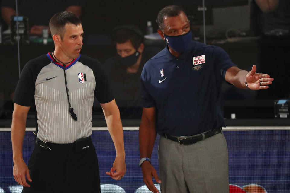 New Orleans Pelicans head coach Alvin Gentry, right, talks with an official during the first half of an NBA basketball game against the Orlando Magic, Thursday, Aug. 13, 2020, in Lake Buena Vista, Fla. (Kim Klement/Pool Photo via AP)