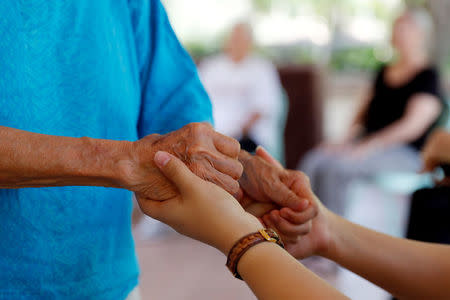 A retired woman is helped by a nurse, while staying at the Care Resort in Chiang Mai, Thailand April 6, 2018. REUTERS/Jorge Silva