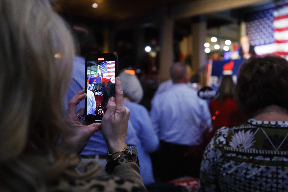 A supporter records Kentucky Sen. Rand Paul's victory speech at the Bowling Green Country Club after defeating Democratic candidate Charles Booker, Tuesday, Nov. 8, 2022, in Bowling Green, Ky. (AP Photo/Michael Clubb)