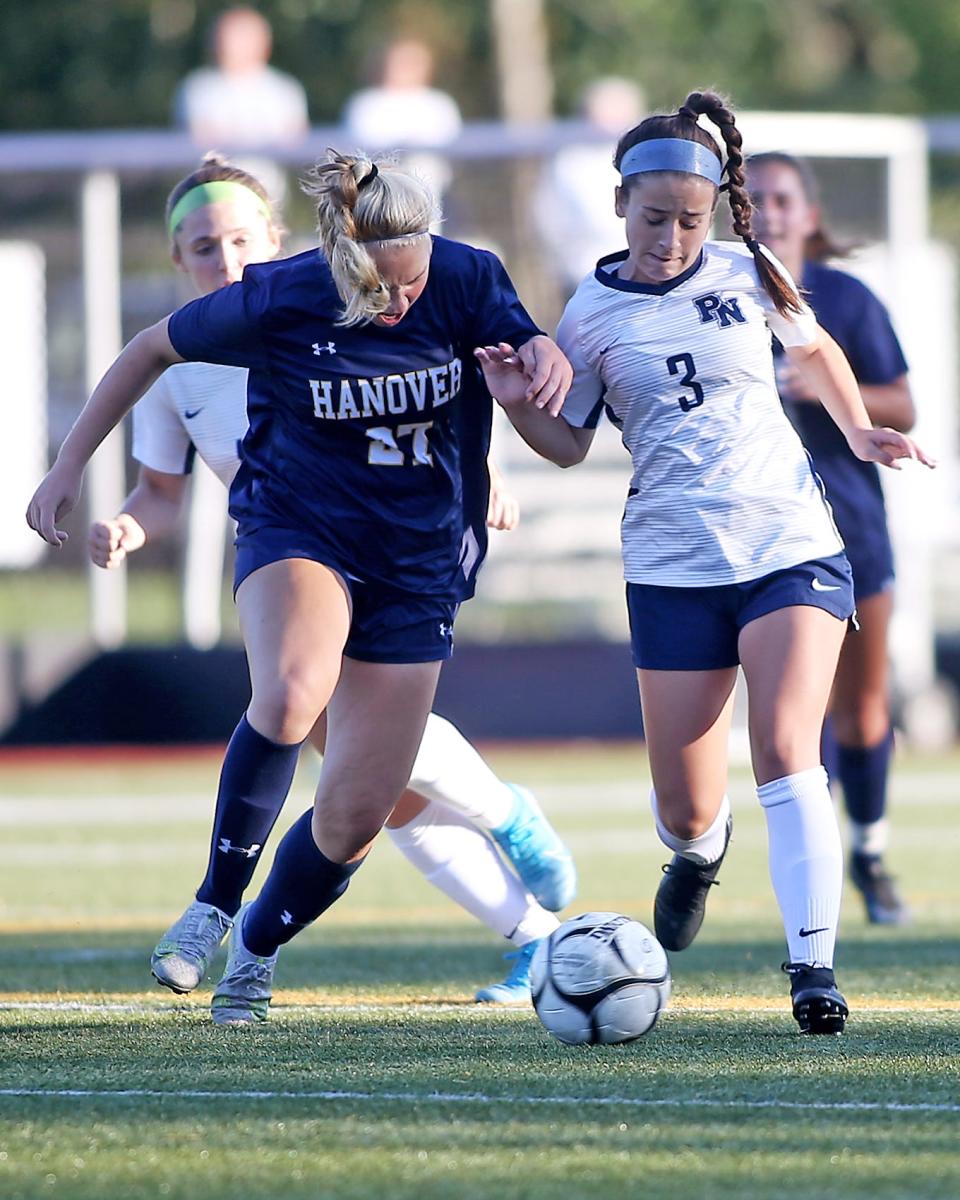 Hanover's Cailyn McCarthy battles Plymouth North's Jessie Durgin for possession in the midfield during second half action of their game against Plymouth North at Hanover High on Thursday, Sept. 15, 2022.