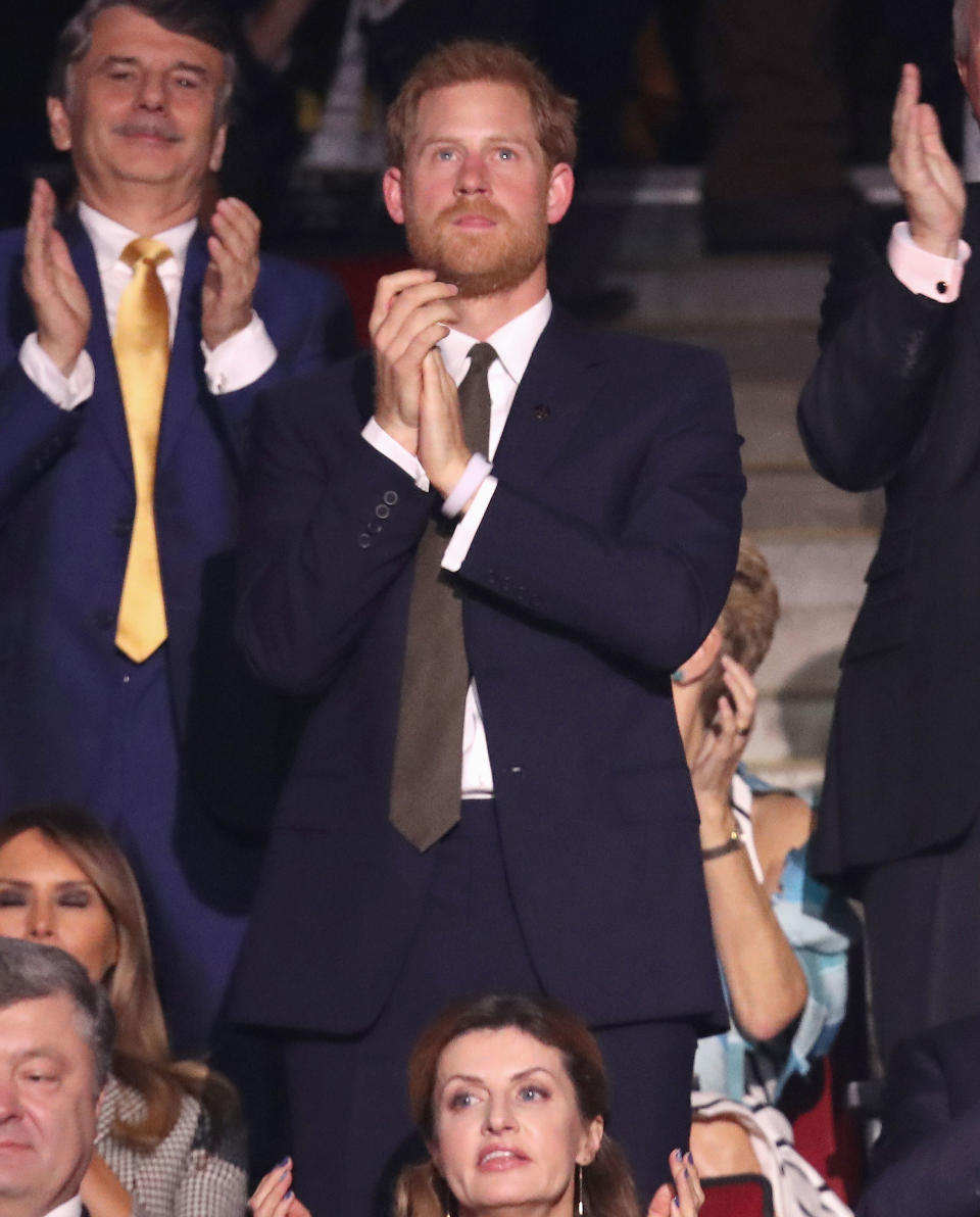 <p>Harry stood and clapped several times during the ceremony before he gave his opening speech.</p>