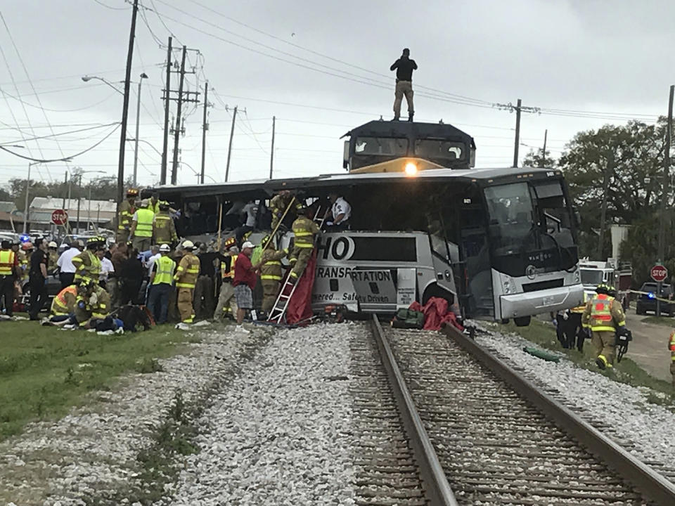 Train hits bus, killing 4