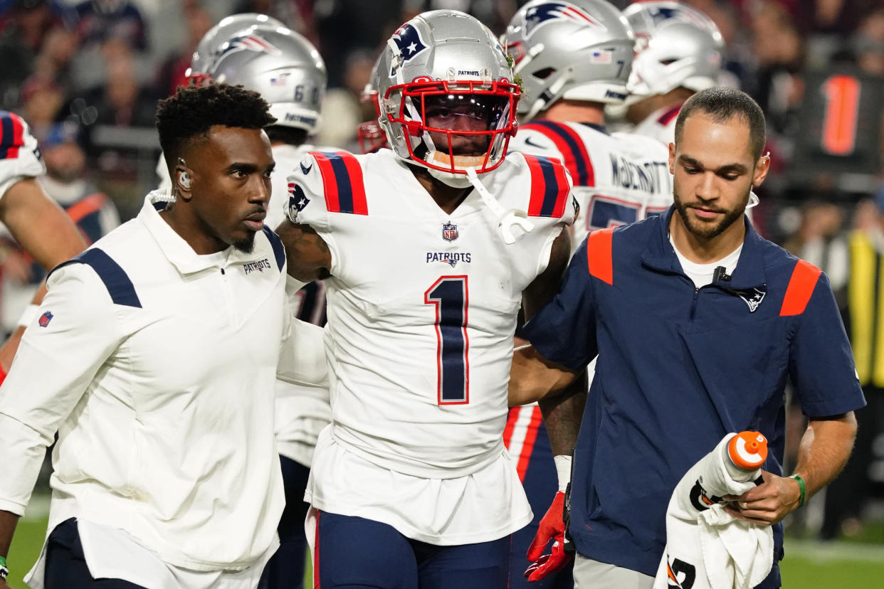 New England Patriots wide receiver DeVante Parker (1) is carried off the field after a play against the Arizona Cardinals during the first half of an NFL football game, Monday, Dec. 12, 2022, in Glendale, Ariz. (AP Photo/Darryl Webb)