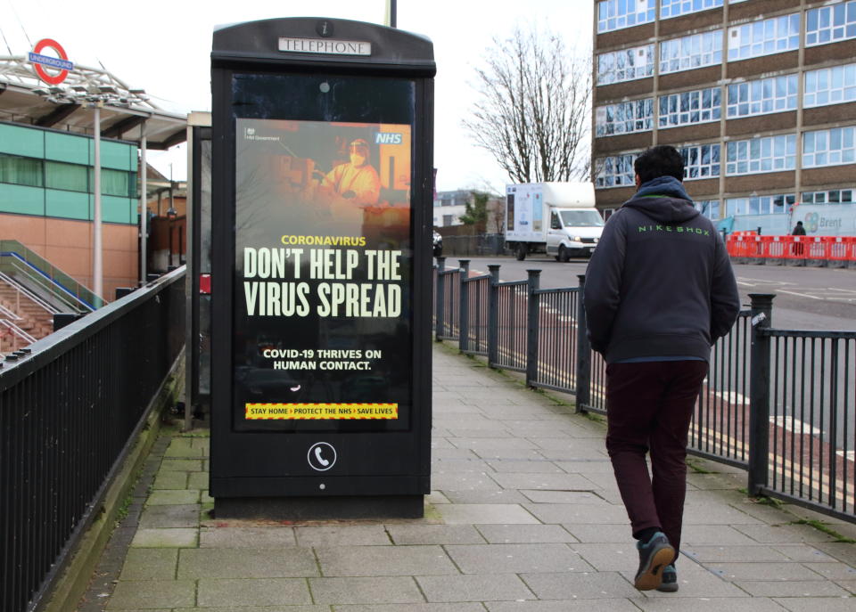 LONDON, UNITED KINGDOM - 2021/01/21: A man walks past a 'Don't Help the Virus spread' warning sign along the Streets of London.
England remains under lockdown as the Prime Minster Boris Johnson refuses to rule out that it may continue past Easter and into the summer, Covid-19 cases have fallen over the past week, but the UK had a record number of deaths of 1820 yesterday. (Photo by Keith Mayhew/SOPA Images/LightRocket via Getty Images)