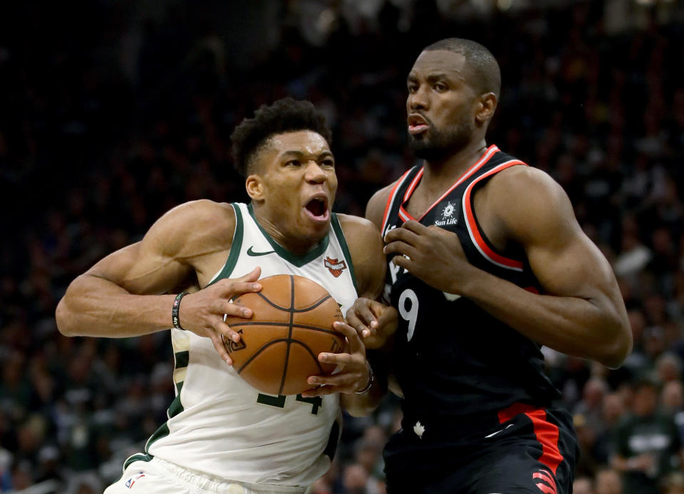 MILWAUKEE, WISCONSIN – MAY 17: Giannis Antetokounmpo #34 of the Milwaukee Bucks dribbles the ball while being guarded by Serge Ibaka #9 of the Toronto Raptors in the third quarter during Game Two of the Eastern Conference Finals of the 2019 NBA Playoffs at the Fiserv Forum on May 17, 2019 in Milwaukee, Wisconsin. NOTE TO USER: User expressly acknowledges and agrees that, by downloading and or using this photograph, User is consenting to the terms and conditions of the Getty Images License Agreement. (Photo by Jonathan Daniel/Getty Images)