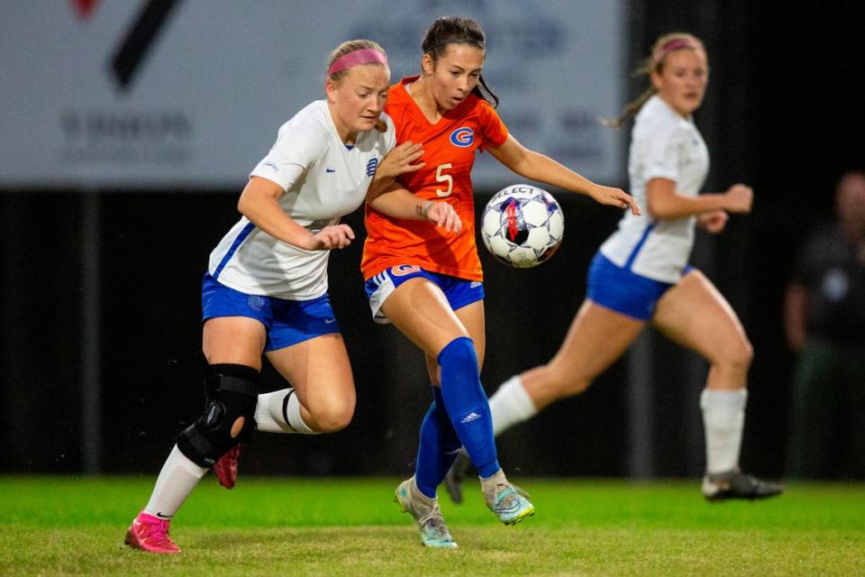 Gulfport’s Kate Ackerman and Ocean Springs’ Jaylen Bodry fight for the ball during the 6A South State Championship game in Gulfport on Tuesday, Jan. 31, 2023.