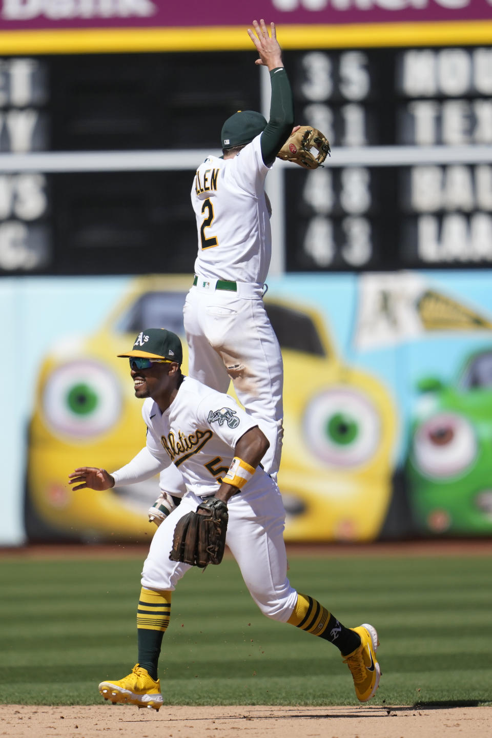 Oakland Athletics' Tony Kemp, bottom, and Nick Allen (2) celebrate after the Athletics defeated the Toronto Blue Jays in a baseball game in Oakland, Calif., Wednesday, Sept. 6, 2023. (AP Photo/Jeff Chiu)