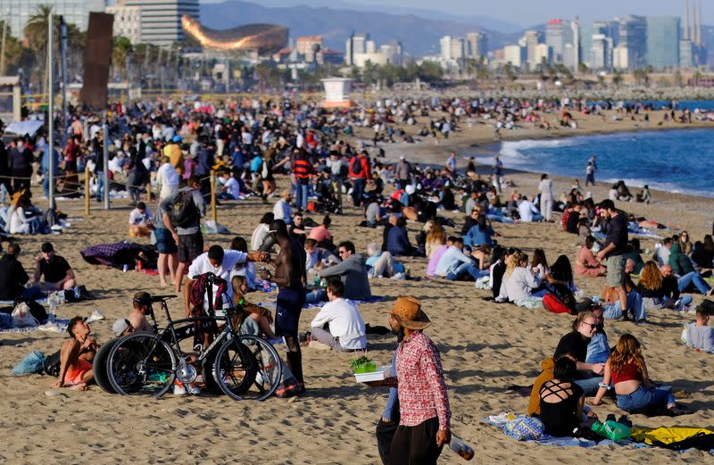 FILE PHOTO: People spend time at Barceloneta beach, in Barcelona