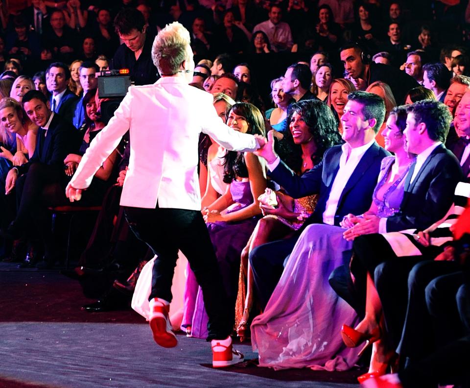 Jedward joke with Simon Cowell during the National Television Awards 2010, at the 02 Arena, London.