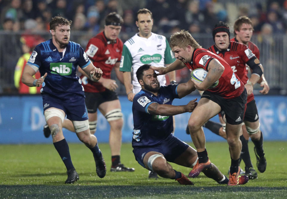 Crusaders Jack Goodhue fends off Blues Akira Ioane during their Super Rugby match in Christchurch, New Zealand, Saturday, May 25, 2019. (AP Photo/Mark Baker)