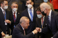 U.S. President Joe Biden, right, is greeted by Turkey's President Recep Tayyip Erdogan, center, during a plenary session at a NATO summit in Brussels, Monday, June 14, 2021. (AP Photo/Olivier Matthys, Pool)