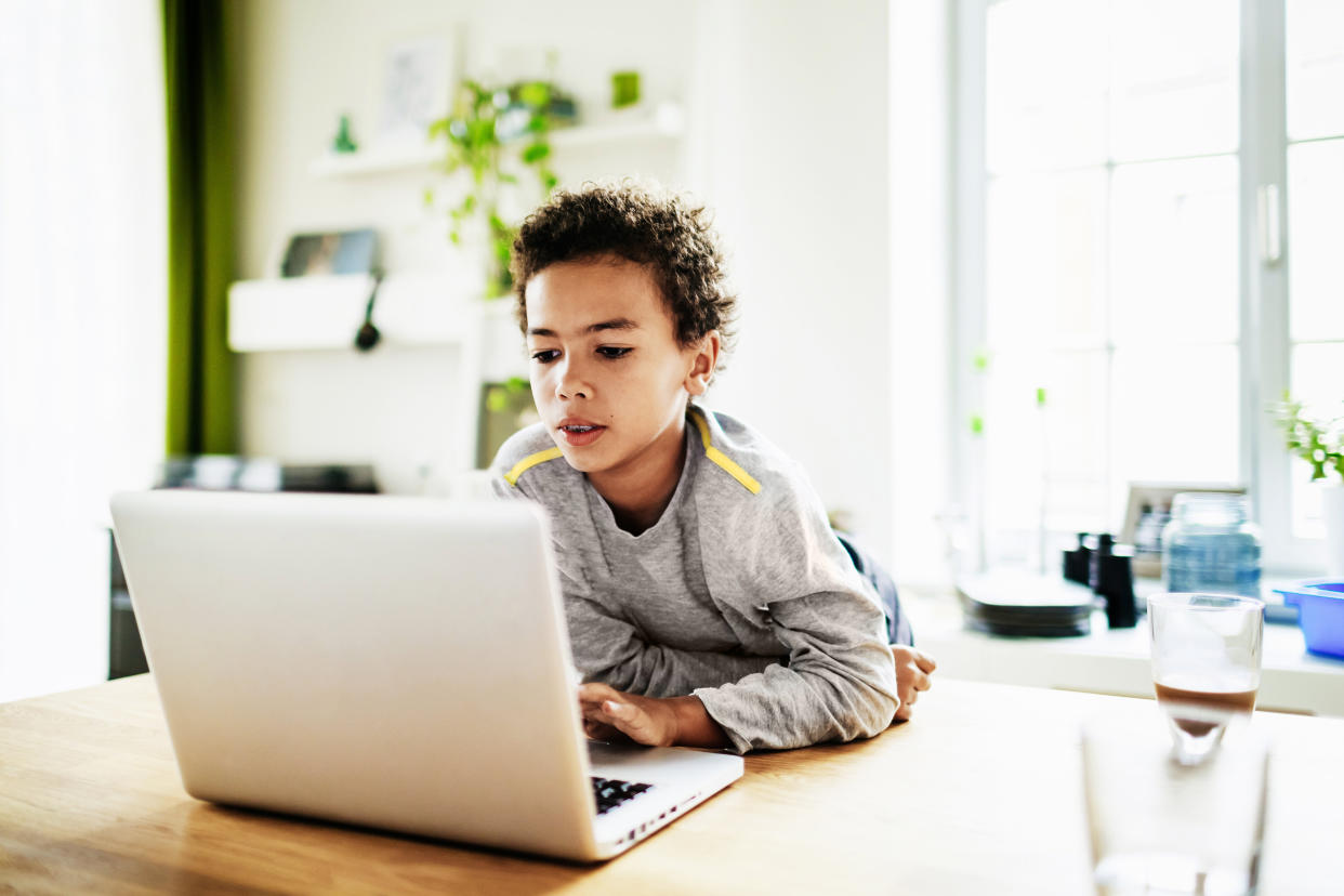 A young boy at home over the weekend using a laptop to do his homework. (Photo: Tom Werner via Getty Images)