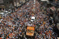 In this Thursday, April 24, 2014, file photo, India's main opposition Bharatiya Janata Party (BJP)'s prime ministerial candidate Narendra Modi, center, waves to supporters as he arrives in an open vehicle to file his nomination in Varanasi, India. India has been embroiled in protests since December, when Parliament passed a bill amending the country's citizenship law. (AP Photo/ Rajesh Kumar Singh, File)