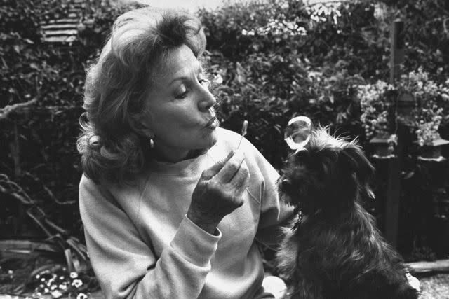<p>Acey Harper/Getty</p> Phyllis Coates blows bubbles with her dog.