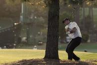 Patrick Reed of the U.S. hits from next to a tree on the 17th fairway during second round play of the 2018 Masters golf tournament at the Augusta National Golf Club in Augusta, Georgia, U.S., April 6, 2018. REUTERS/Jonathan Ernst