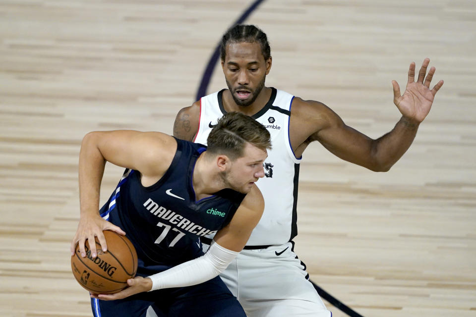 Los Angeles Clippers' Kawhi Leonard, right, will face the Dallas Mavericks and Luka Doncic (77) in the first round of the playoffs. (AP Photo/Ashley Landis, Pool)