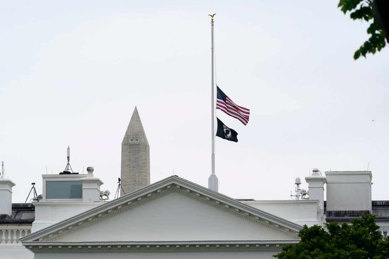 The American flag flies at half-staff at the White House in Washington, Thursday, May 12, 2022, as the Biden administration commemorates 1 million American lives lost due to COVID-19.