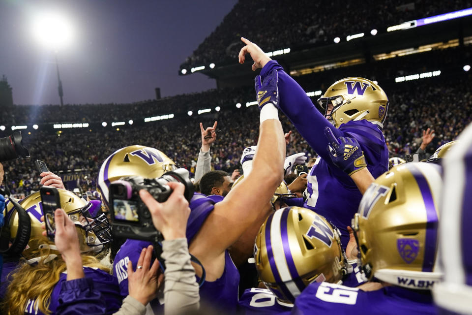 Washington place-kicker Grady Gross lifts his hand up as he is lifted by teammates after kicking the game-winning field goal in a win over Washington State in an NCAA college football game, Saturday, Nov. 25, 2023, in Seattle. (AP Photo/Lindsey Wasson)