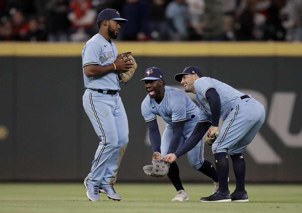 Toronto Blue Jays' Teoscar Hernandez, left, celebrates with teammates at the end of a baseball game against the Atlanta Braves on Wednesday, May 12, 2021, in Atlanta. (AP Photo/Ben Margot)