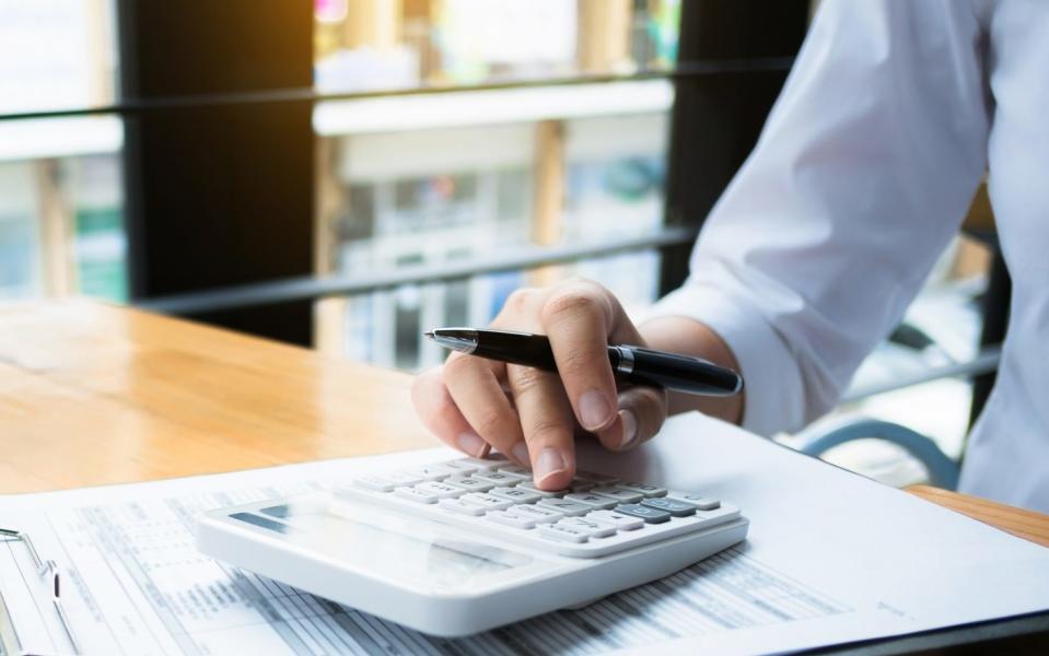 man with calculator doing his accounts