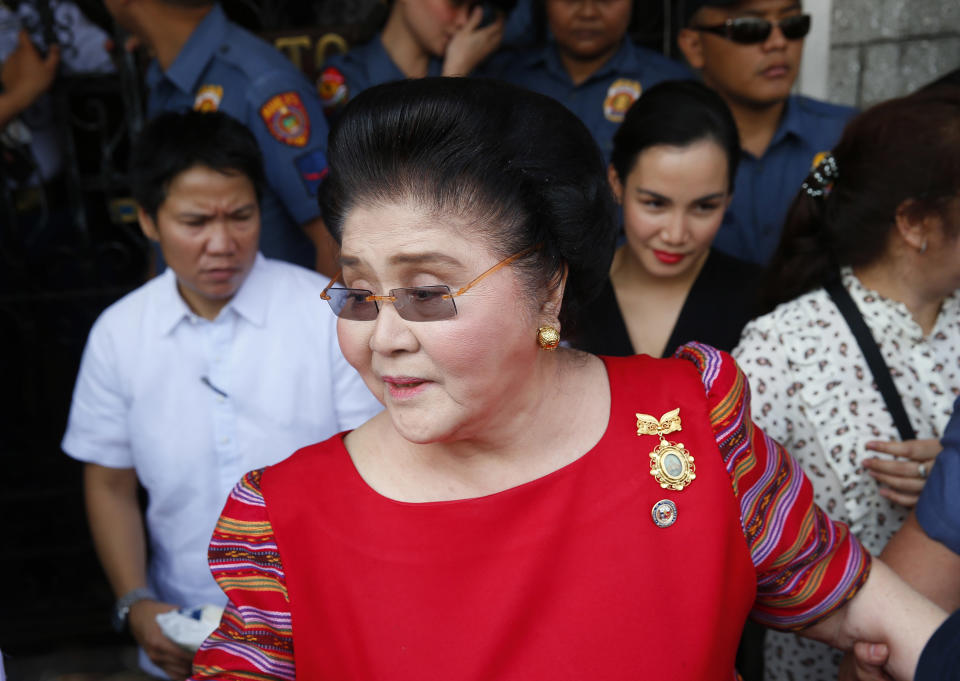 FILE - In this Oct. 16, 2018, file photo, former Philippines first lady and widow of the late dictator Ferdinand Marcos, Congresswoman Imelda Marcos arrives at the Commission on Elections to lend her support for her daughter Governor Imee Marcos in filing her Certificate of Candidacy or COC for a Senate seat in the May 2019 midterm elections in Manila, Philippines. A Philippine court found former first lady Imelda Marcos guilty of graft and ordered her arrest Friday, Nov. 9, 2018, in a rare conviction among many corruption cases that she's likely to appeal to avoid jail and losing her seat in Congress. (AP Photo/Bullit Marquez, File)