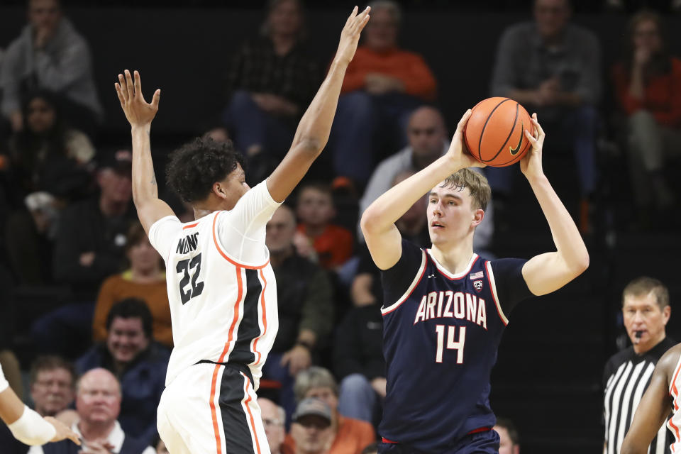 Arizona center Motiejus Krivas (14) looks to pass the ball as Oregon State forward Thomas Ndong (22) defends during the first half of an NCAA college basketball game Thursday, Jan. 25, 2024, in Corvallis, Ore. (AP Photo/Amanda Loman)