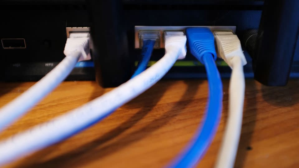 Ethernet cables are seen running from the back of a wireless router in Washington, DC on March 21, 2019. - Mandel Ngan/AFP/Getty Images