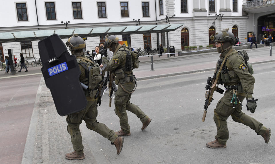 Armed police patrol outside the central station in Stockholm after a truck crashed into a department store injuring several people in a different part of Stockholm, Sweden, Friday April 7, 2017. Swedish Prime Minister Stefan Lofven says everything indicates a truck that has crashed into a major department store in downtown Stockholm is "a terror attack." (Jessica Gow/ TT News Agency via AP)